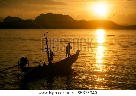 Traditional Fisherman Long Tailed Boat In Koh Phitak Island, Thailand At Sunset.