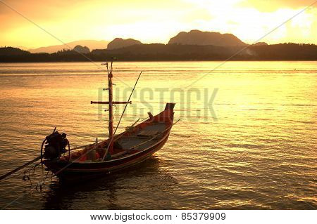 Traditional Fisherman Long Tailed Boat In Koh Phitak Island, Thailand At Sunset.
