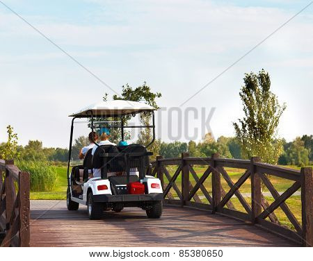 Young Sportive People In The Golfcar