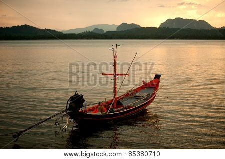 Traditional Fisherman Long Tailed Boat In Koh Phitak Island, Thailand At Sunset.