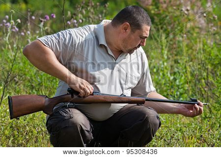 Man Cleans The Barrel Of Rifle
