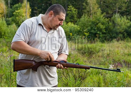 Hunter Cleans Rifle