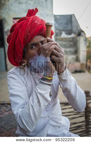 GODWAR REGION, INDIA - 12 FEBRUARY 2015: Rabari tribesman smokes chillum. Rabari or Rewari are an Indian community in the state of Gujarat.