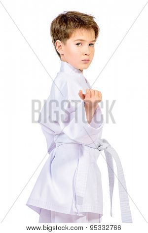 Karate boy in kimono posing in the studio. Sport, martial arts. Isolated over white.