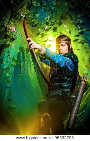 Portrait of a male elf with a bow and arrows in a magical forest.