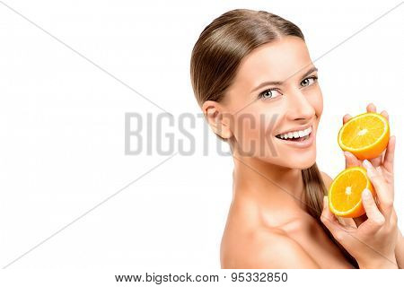Pretty joyful young woman holding fresh juicy oranges. Healthy lifestyle. Healthy eating. Fruits and vegetables. Isolated over white. 