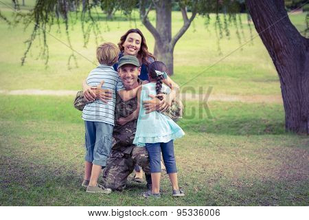 Handsome soldier reunited with family on a sunny day