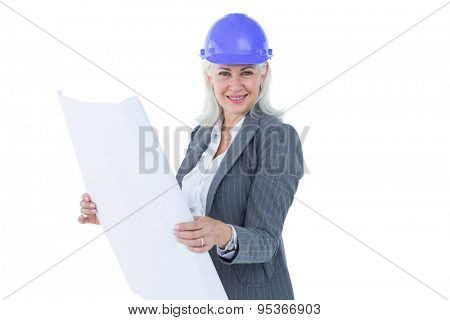 Selfassured businesswoman wearing a helmet against white background