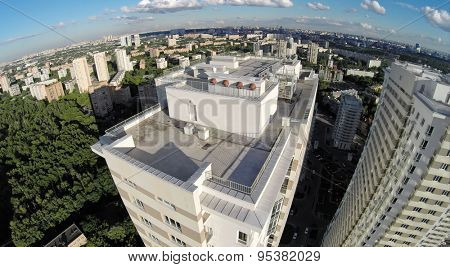 RUSSIA, MOSCOW - JUN 24, 2014: Aerial view of megapolis with tall residential complex at summer sunny day on Elk island. Photo with noise from action camera
