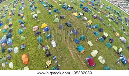 RUSSIA, BOROVSK - JUN 13, 2014: Aerial view of the many different tents on field at ethnofestival Wild mint. Photo with noise from action camera