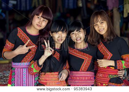 MAI CHAU, VIETNAM, DECEMBER 20, 2015 : Group of tourists Vietnamese girls wearing traditional Hmong ethnicity costume, posing in the village of Mai Chau, Vietnam.