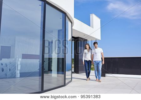 happy young romantic couple have fun relax smile at modern home outdoor terace balcony terace