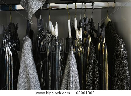 hanger in the dressing room with things in black-and-gray color scheme