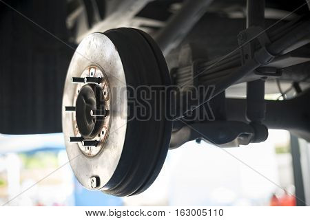 Car Rear drum brake without tire while waiting to get maintenance. selective focued.