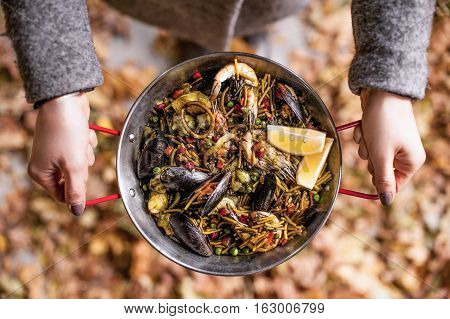 Italian pasta fideua with seafood, oysters, black pasta