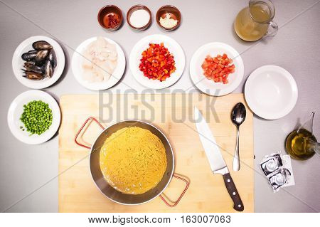 Italian pasta fideua with seafood, oysters, black pasta