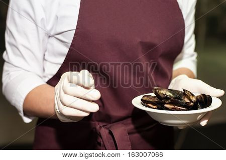 Italian pasta fideua with seafood, oysters, black pasta