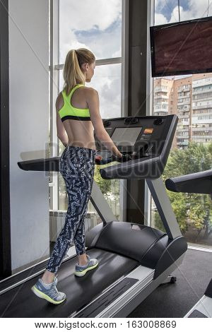 Young Woman Goes In For Sports At Gym