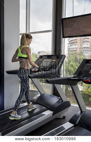 Young Woman Goes In For Sports At Gym