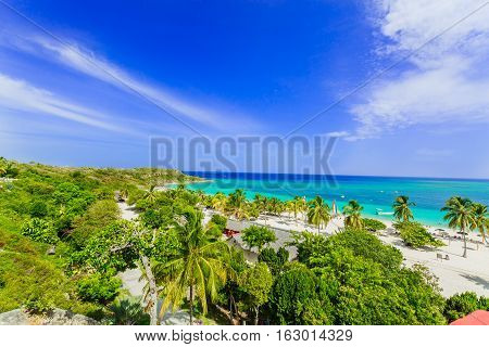 stunning gorgeous beautiful, amazing view of Holguin province tropical inviting beach and tranquil azure turquoise ocean on blue sky background