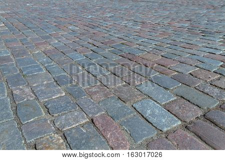 Old road paved with the cobble stones street of Tallinn stock photo