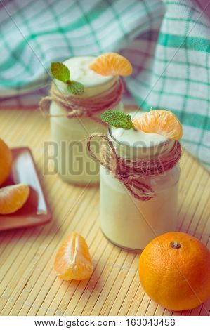 Fresh Organig Natural White Yogurt In Glass Jars With Tangerine And Mint