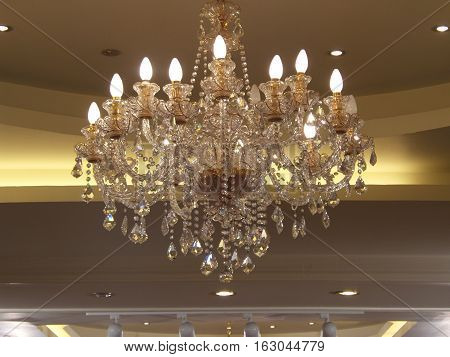 Close-up to beautiful chandelier hanging on ceiling