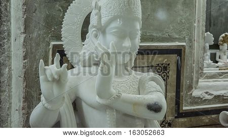 Statues of Hindu God Krishna Gopala Crafts and Arts of India. Murti handmade Manufacturing in Jaipur (Rajasthan). Indian God sculpture made of white marble. Ancient Traditions and Crafts of India