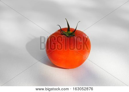 Fresh tomato on white background close up