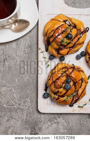 Homemade pumpkin cinnamon yeasted buns, fall baking concept, top view