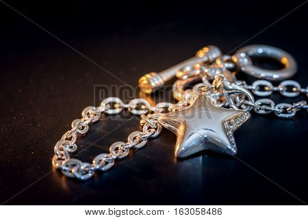 Beads and gems bracelet isolated on dark blue.