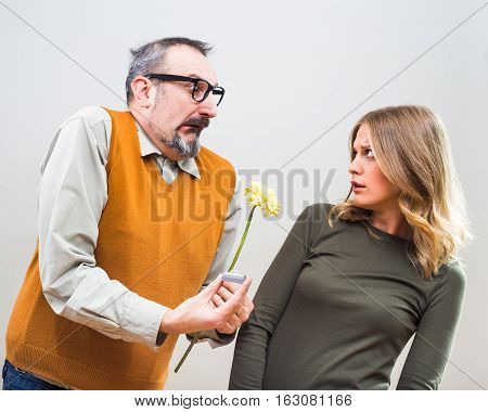 Nerdy man wants to marry to a beautiful woman but she is terrified, she doesn't want to marry.