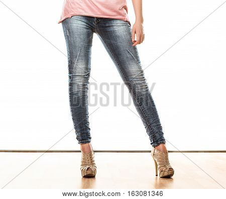 Fashion and people concept. Woman legs in denim trousers platform high heels shoes casual style isolated on white background