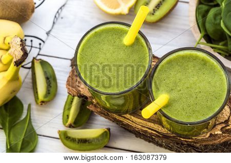 Fresh and healthy green smoothie with spinach,banana and kiwi. Vegetarian breakfasts. Picture with space for text or logos.