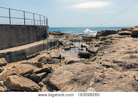 Rocky Shoreline Against Ocean Sky Coastal Landscape