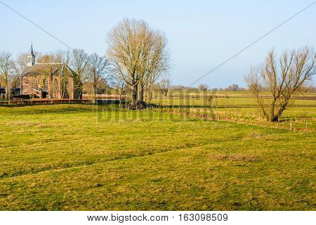 The Reformed church in the Dutch village of Giessen is situated outside the dike on a mound; parts of the church building dating from the 14th century.