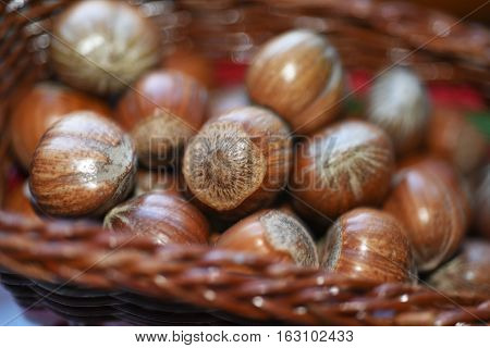 Macro Photo Of Nuts In Straw Plate.