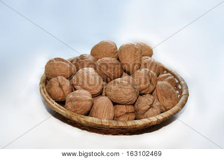 Macro Photo Of Nuts In Straw Plate.