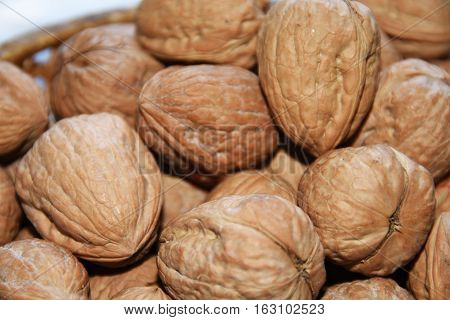 Macro Photo Of Nuts In Straw Plate.