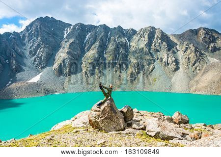 A Man On A Huge Rock Performs The Asanas.