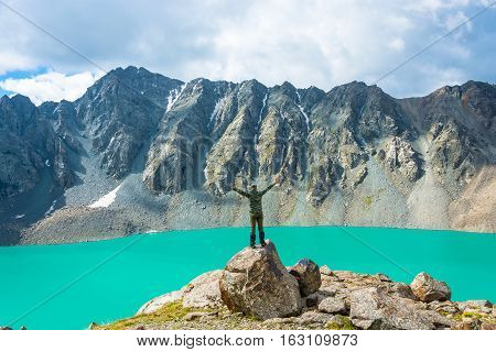 A Man On A Huge Rock Performs The Asanas.