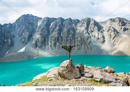A Man On A Huge Rock Performs The Asanas.