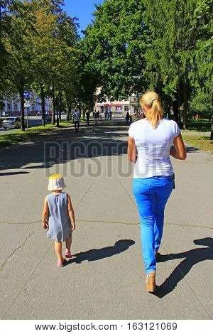 Chernihiv / Ukraine. 28 August 2016: fashionable woman walk with her little daughter in the city park of Chernihiv. 28 August 2016 in Chernihiv / Ukraine.