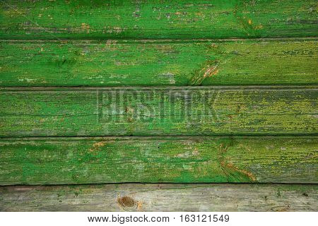Background texture of old wooden wall. Vintage wood surface is naturally aged. Peeling green paint. Grunge background