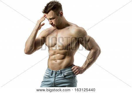 A young man with a beautiful physique thinking on a white background. Isolate