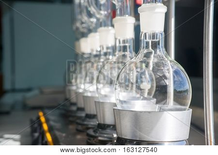 Laboratory equipment glass bottles round bottom flask on heating mantle Soxhlet Extraction
