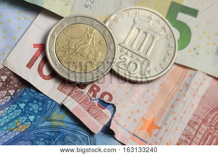 Vintage greek Drachma coins on european banknotes