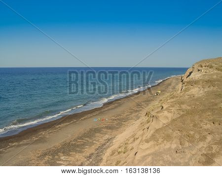 Tourists Enjoying Vlichada Beach On The Island Of Santorini