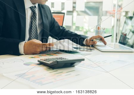 businessman working plan the business and analysis many chart graph. Film effected photo.