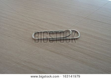 Close-up to paperclip on a wooden table